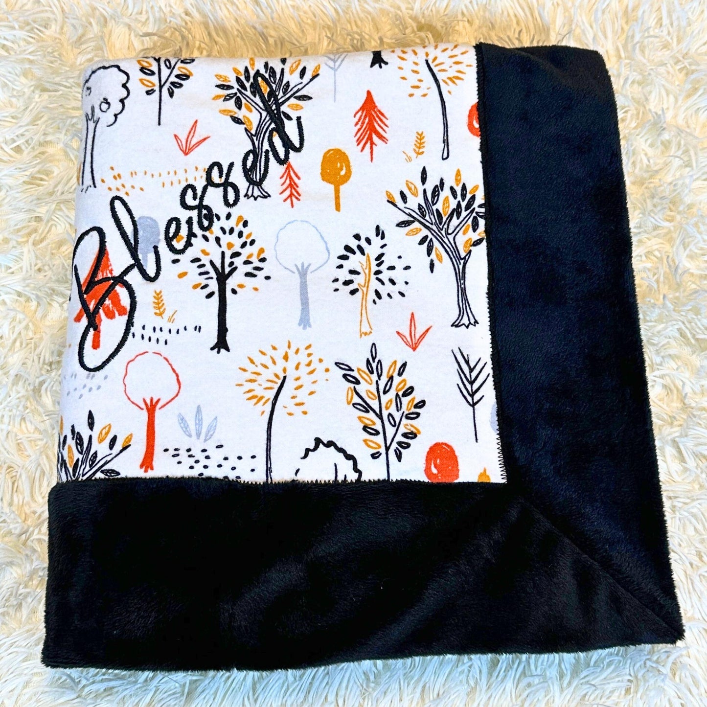 black plush minky baby blanket with a Harvest themed flannel print on the other side