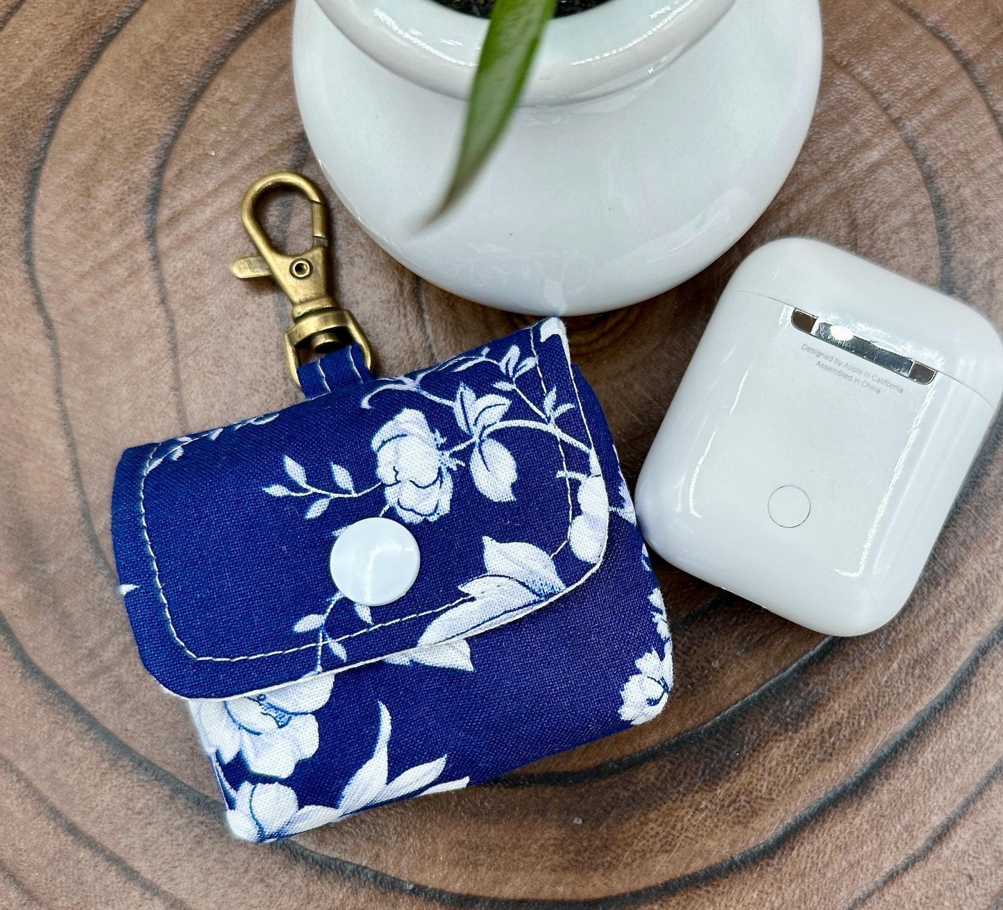 Wireless earbud case, Elegant Navy fabric with White flowers with snap closure and swivel clasp for protection and convenience, 3X3X.75"