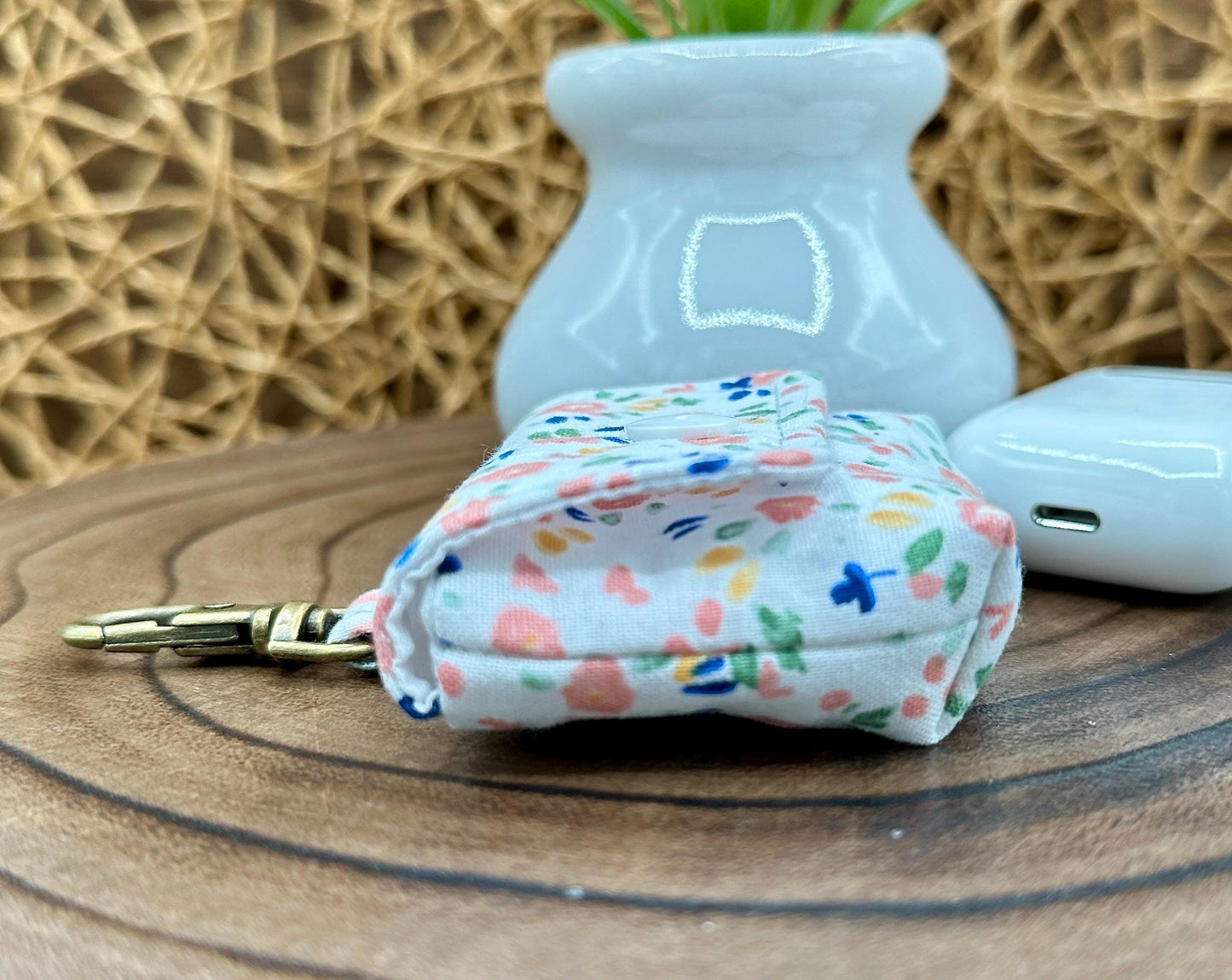 Wireless earbud case, Dainty Pink floral fabric With Blue Leaves; snap closure and swivel clasp for stylish convenience and security 3X3X.75