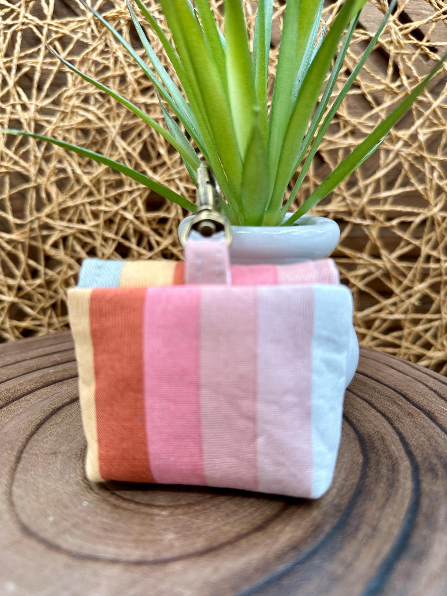 Wireless earbud case, pastel striped fabric with snap closure and swivel clasp for added protection and convenience, 3X3X.75"