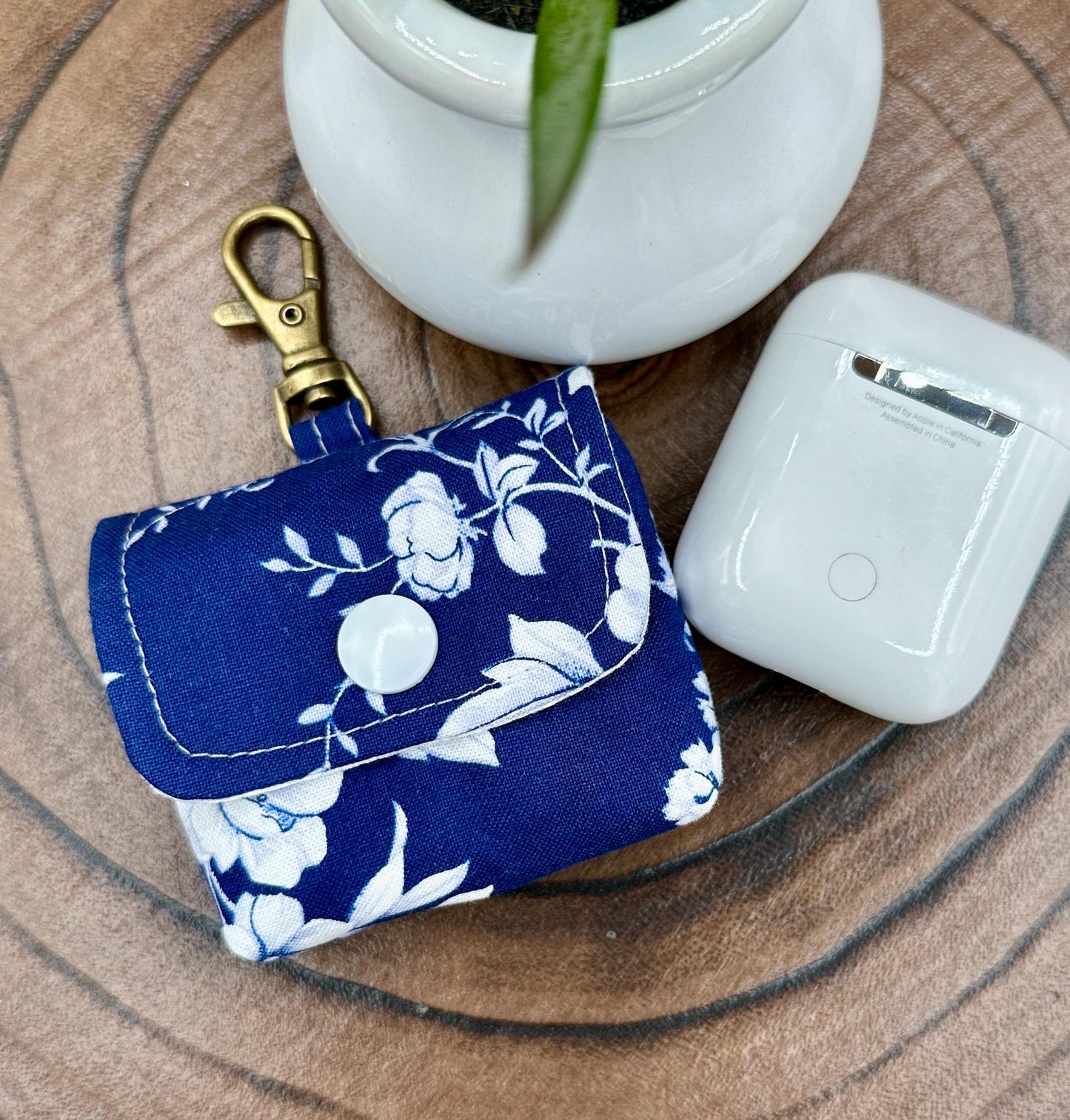 Wireless earbud case, Elegant Navy fabric with White flowers with snap closure and swivel clasp for protection and convenience, 3X3X.75"