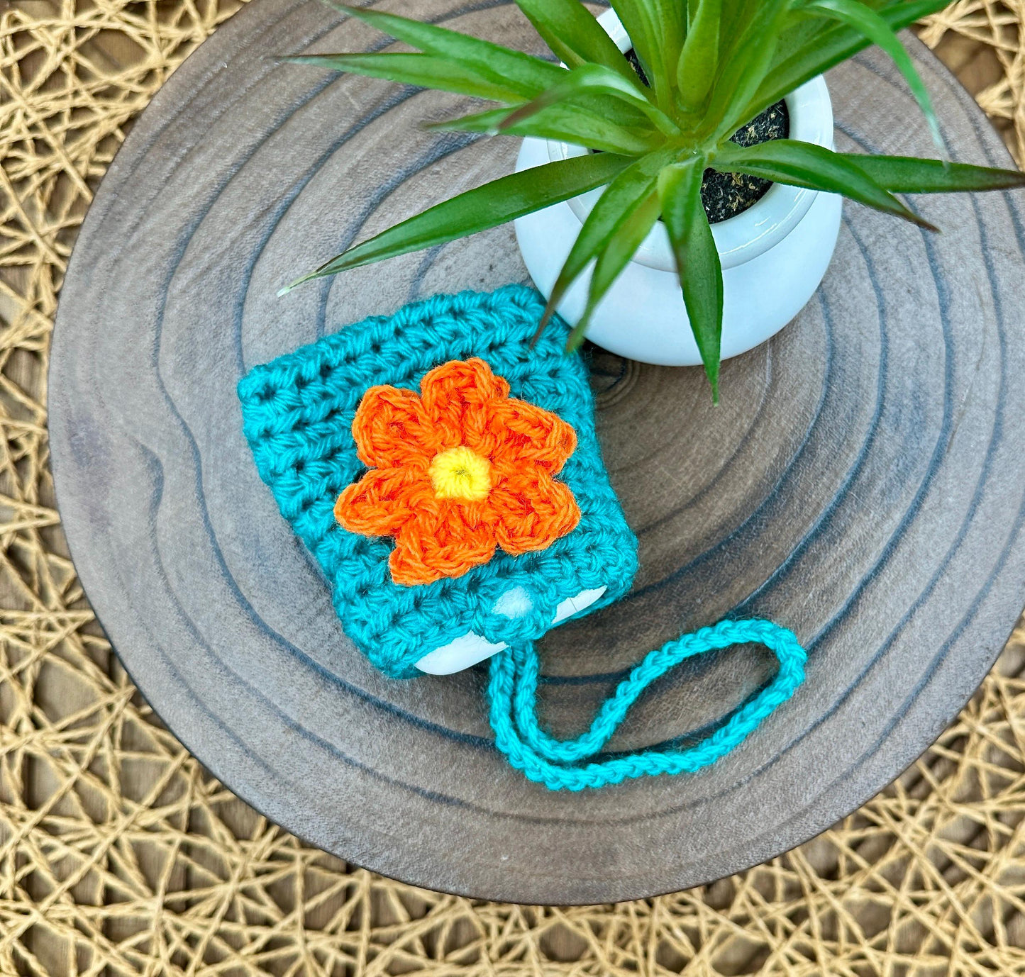 Blue Crocheted Wireless earbud case, compatible with AirPods, measures 3 T 3 H .25 D, Pretty Raised Orange Flower Granny Square Design