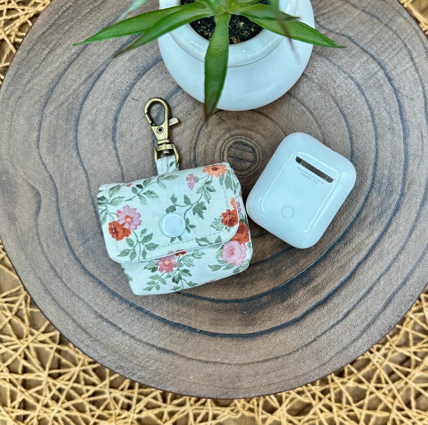 Wireless earbud case, Dainty Rust and Pink floral fabric with snap closure and swivel clasp for added protection and convenience, 3X3X.75"