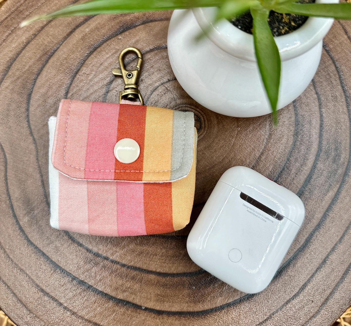 Wireless earbud case, pastel striped fabric with snap closure and swivel clasp for added protection and convenience, 3X3X.75"