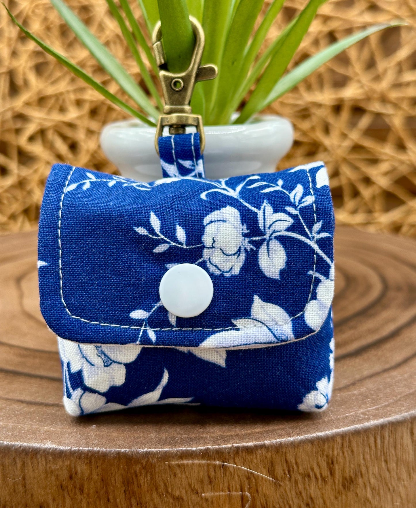 Wireless earbud case, Elegant Navy fabric with White flowers with snap closure and swivel clasp for protection and convenience, 3X3X.75"