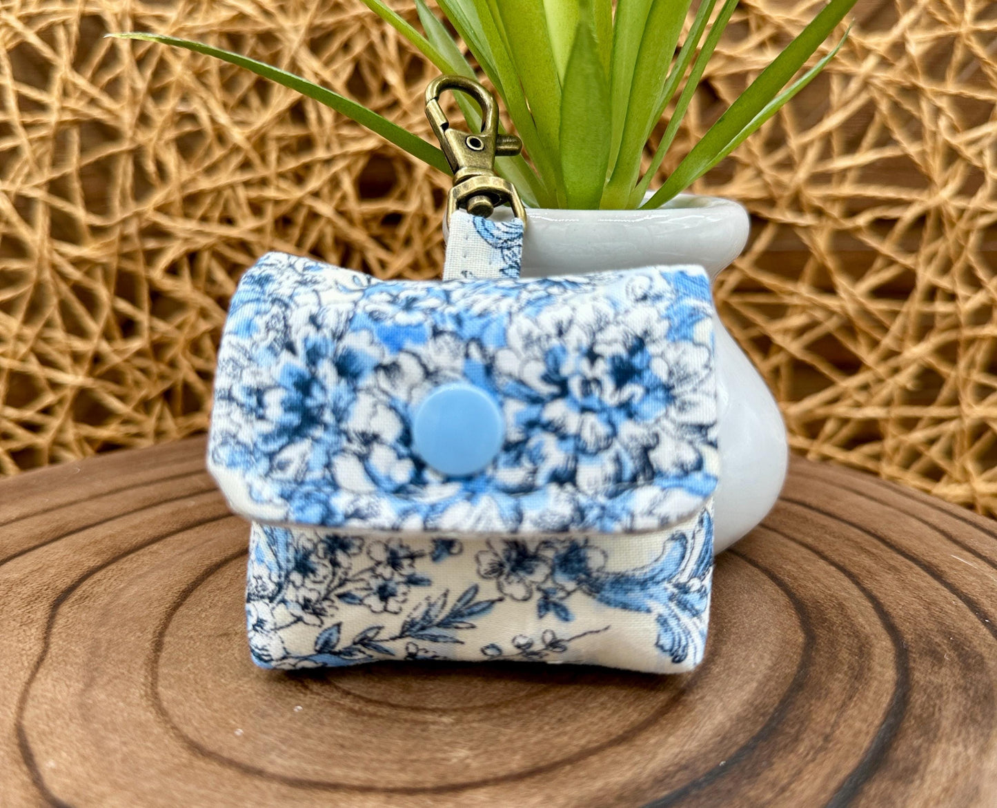 Wireless earbud case, elegant blue floral fabric with snap closure and swivel clasp for added protection and convenience, 3X3X.75"