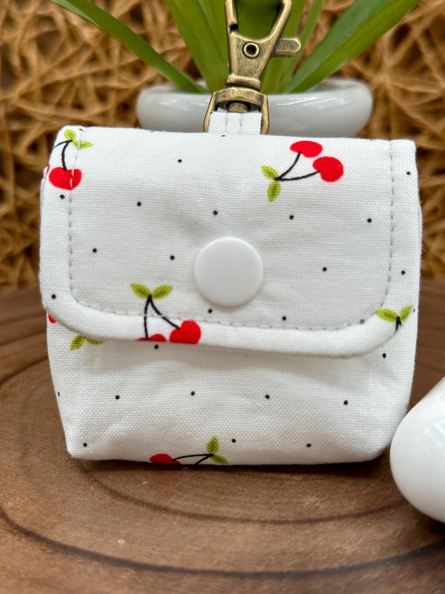 Wireless earbud case, Red Cherry Print Fabric with snap closure and swivel clasp for added protection and convenience, 3X3X.75"