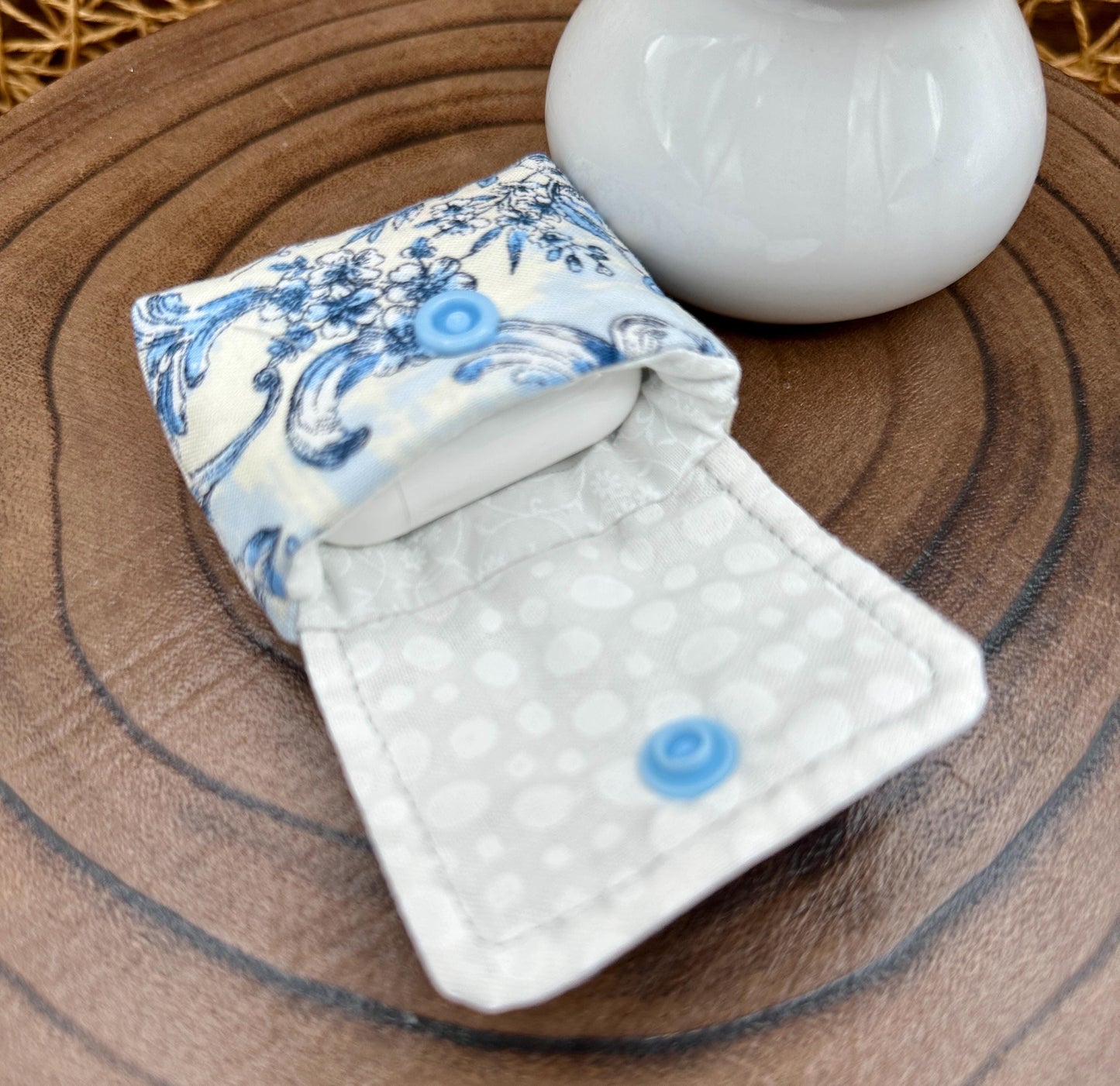 Wireless earbud case, elegant blue floral fabric with snap closure and swivel clasp for added protection and convenience, 3X3X.75"