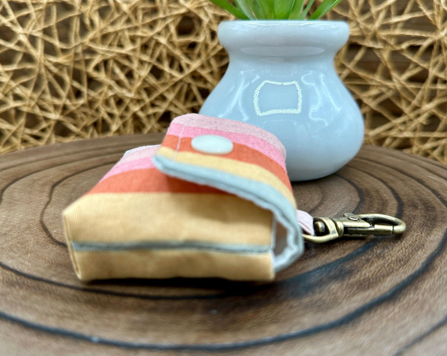 Wireless earbud case, pastel striped fabric with snap closure and swivel clasp for added protection and convenience, 3X3X.75"