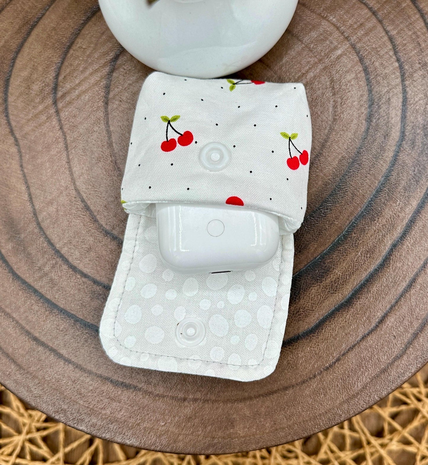 Wireless earbud case, Red Cherry Print Fabric with snap closure and swivel clasp for added protection and convenience, 3X3X.75"
