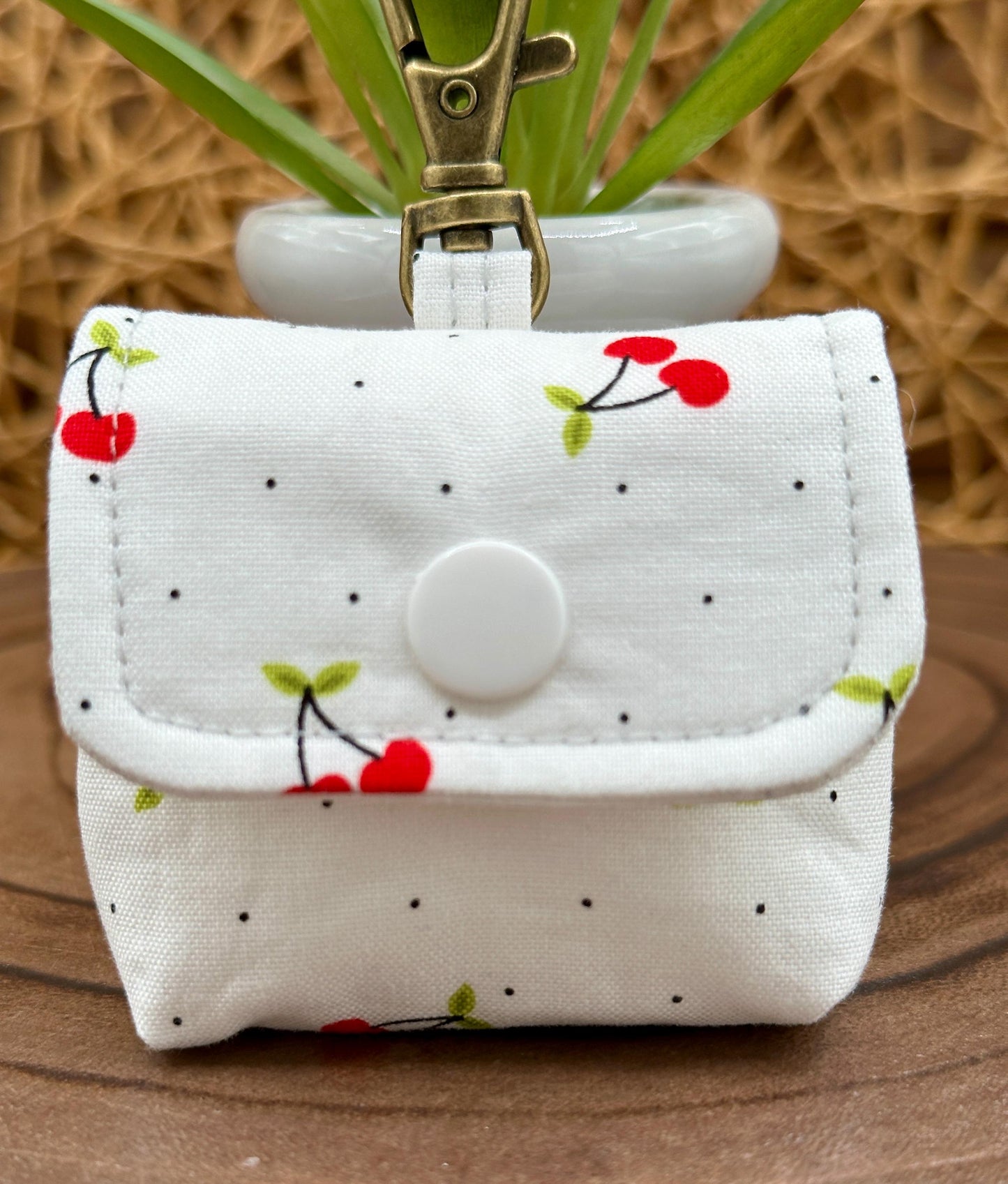 Wireless earbud case, Red Cherry Print Fabric with snap closure and swivel clasp for added protection and convenience, 3X3X.75"