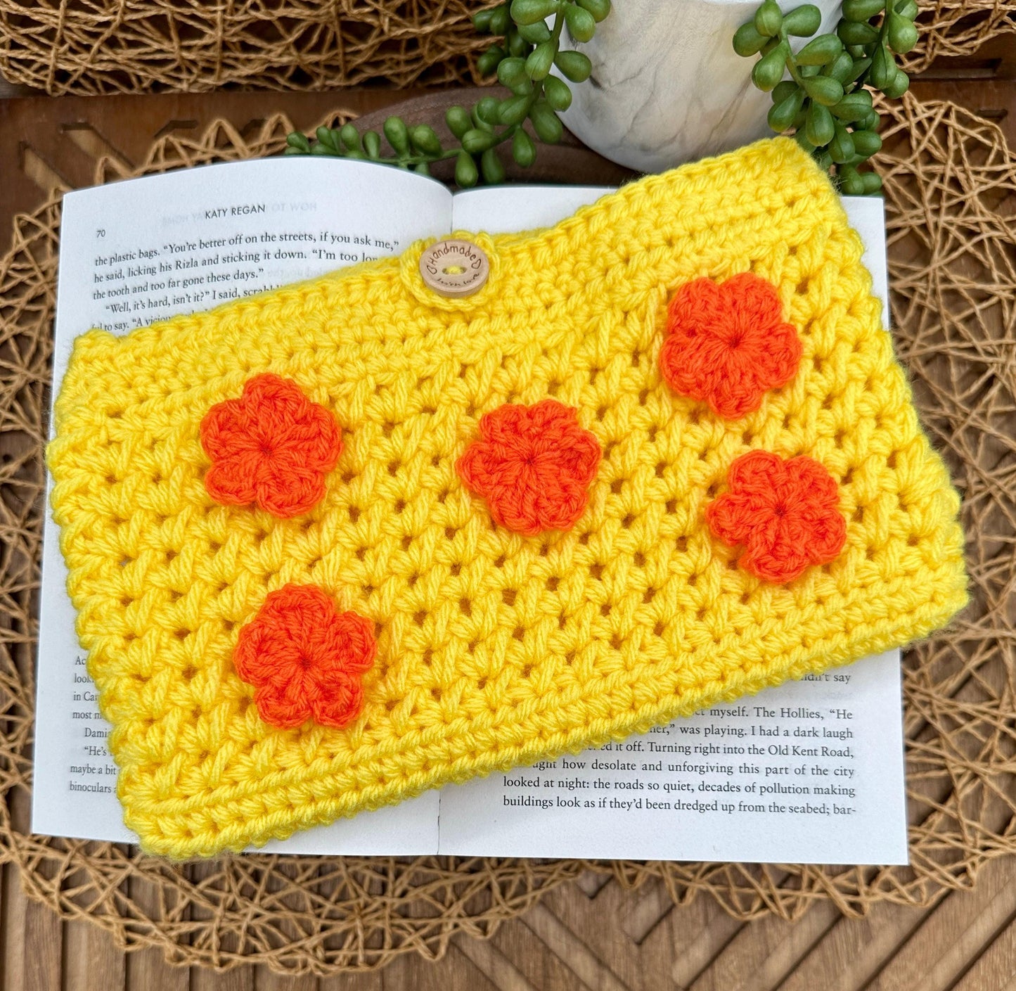 Yellow Crocheted book sleeve with orange flowers
