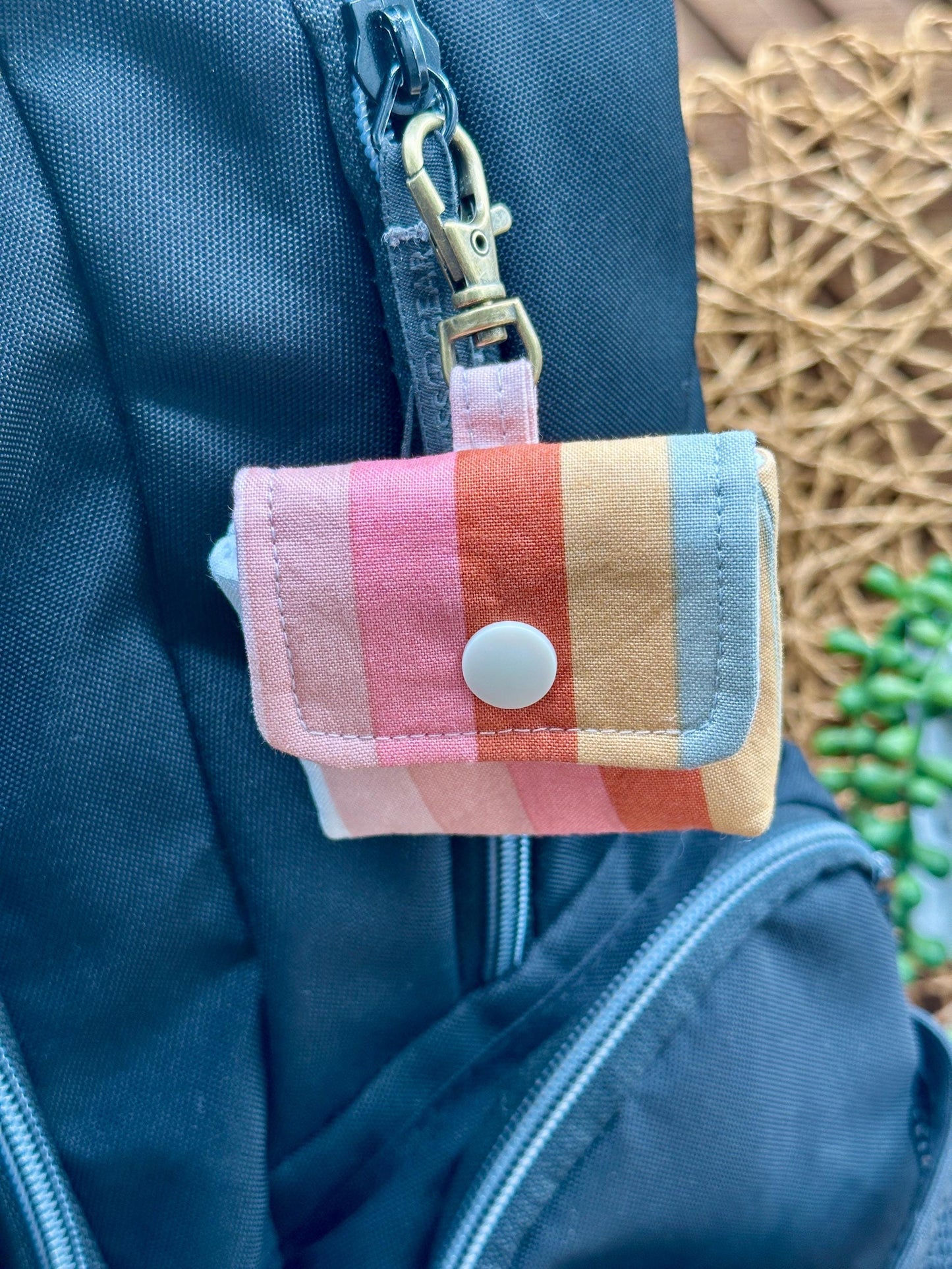 Wireless earbud case, pastel striped fabric with snap closure and swivel clasp for added protection and convenience, 3X3X.75"