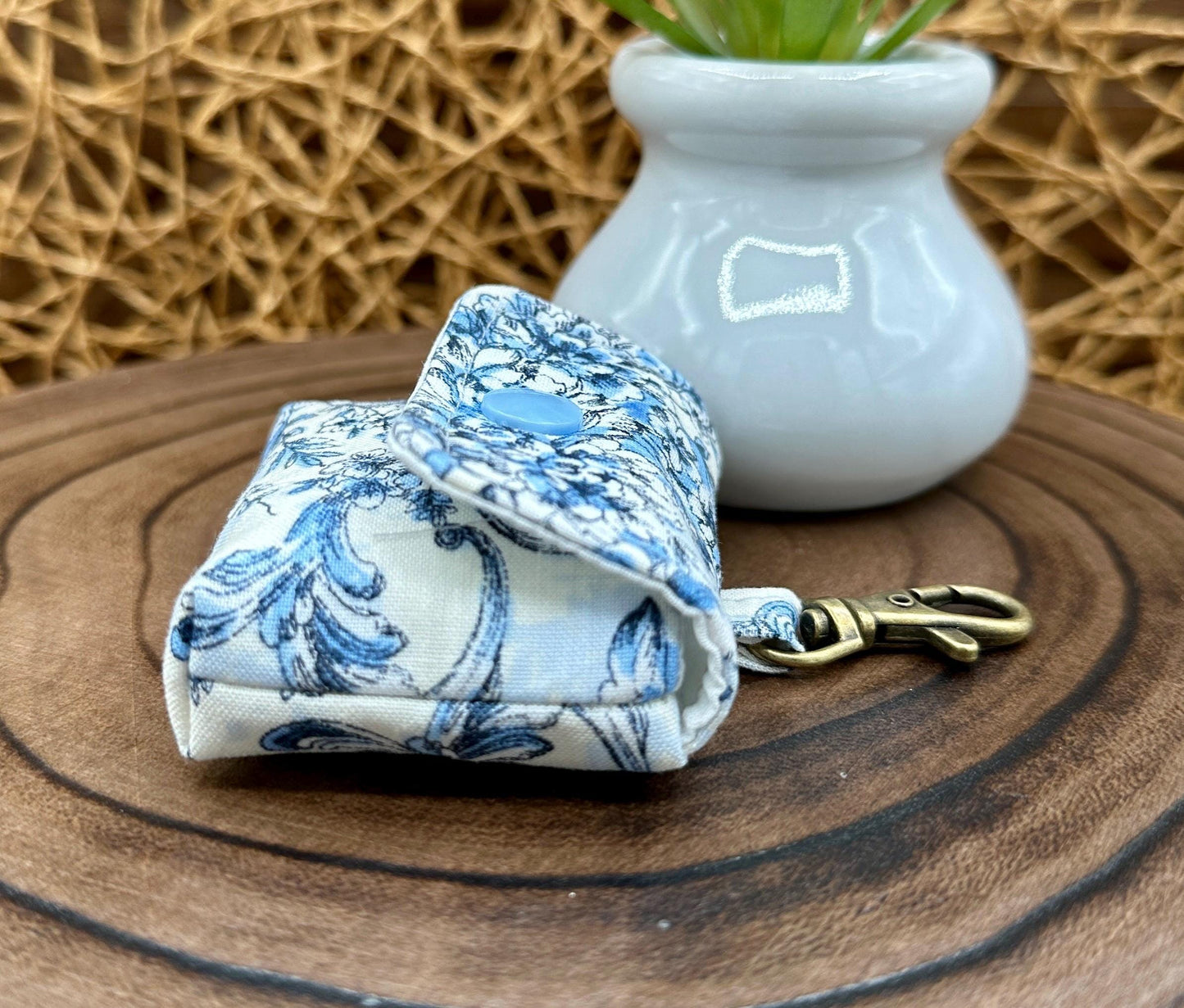 Wireless earbud case, elegant blue floral fabric with snap closure and swivel clasp for added protection and convenience, 3X3X.75"