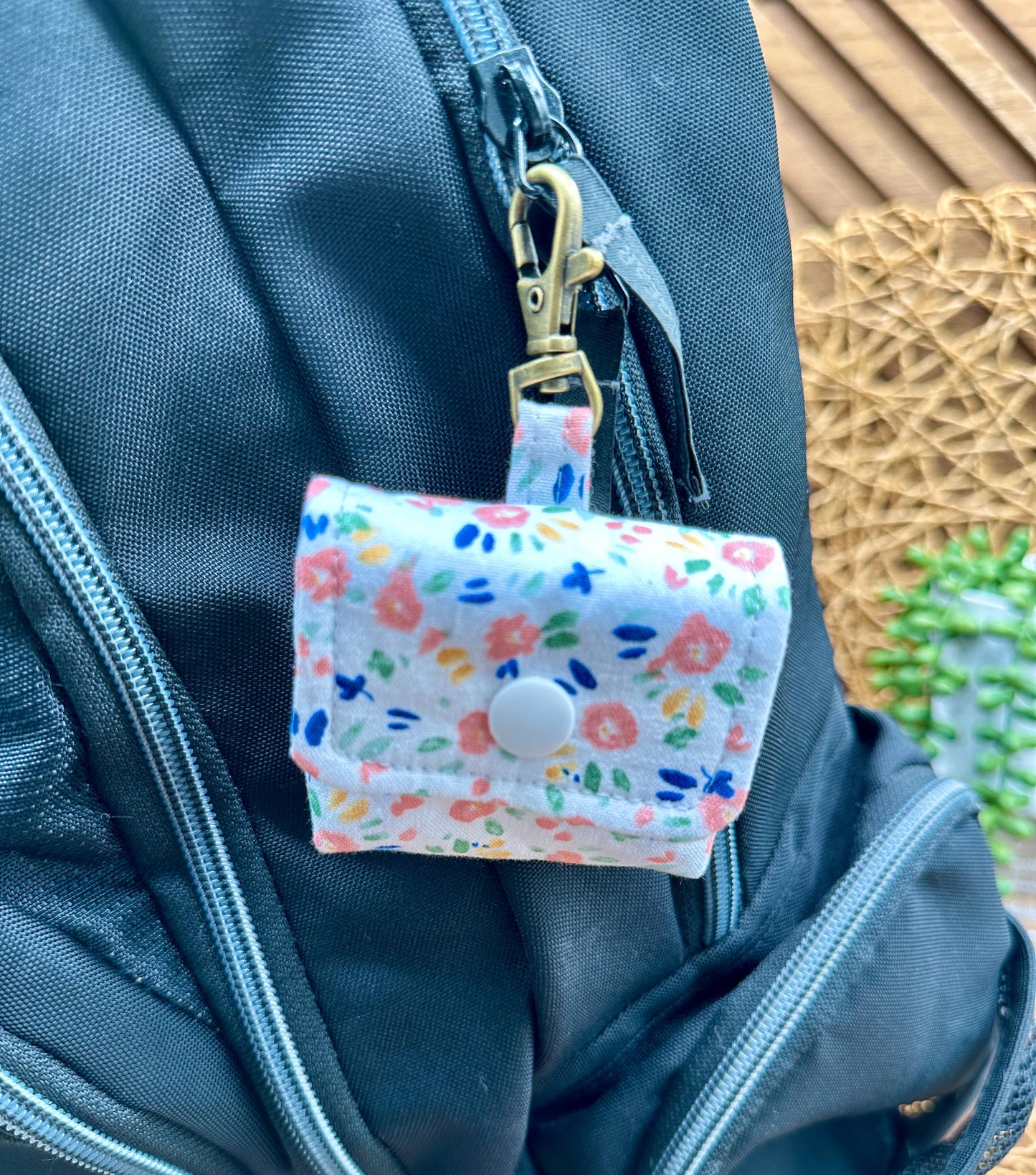 Wireless earbud case, Dainty Pink floral fabric With Blue Leaves; snap closure and swivel clasp for stylish convenience and security 3X3X.75