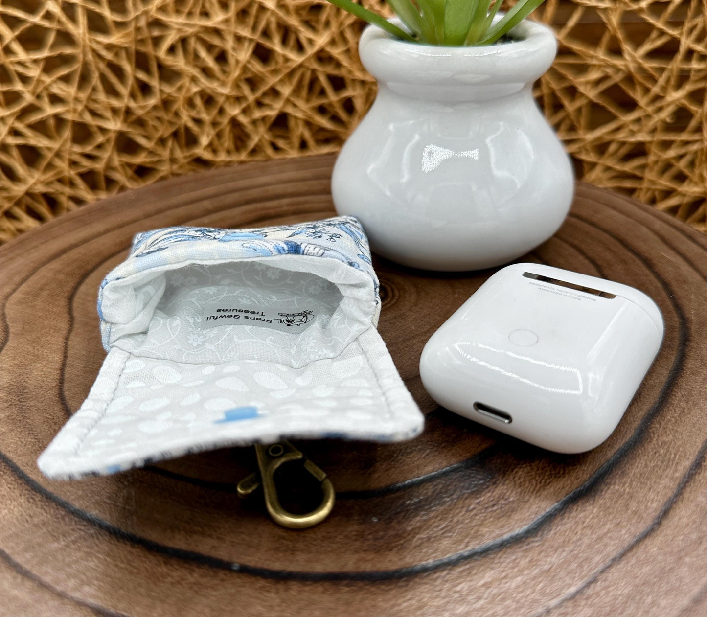 Wireless earbud case, elegant blue floral fabric with snap closure and swivel clasp for added protection and convenience, 3X3X.75"