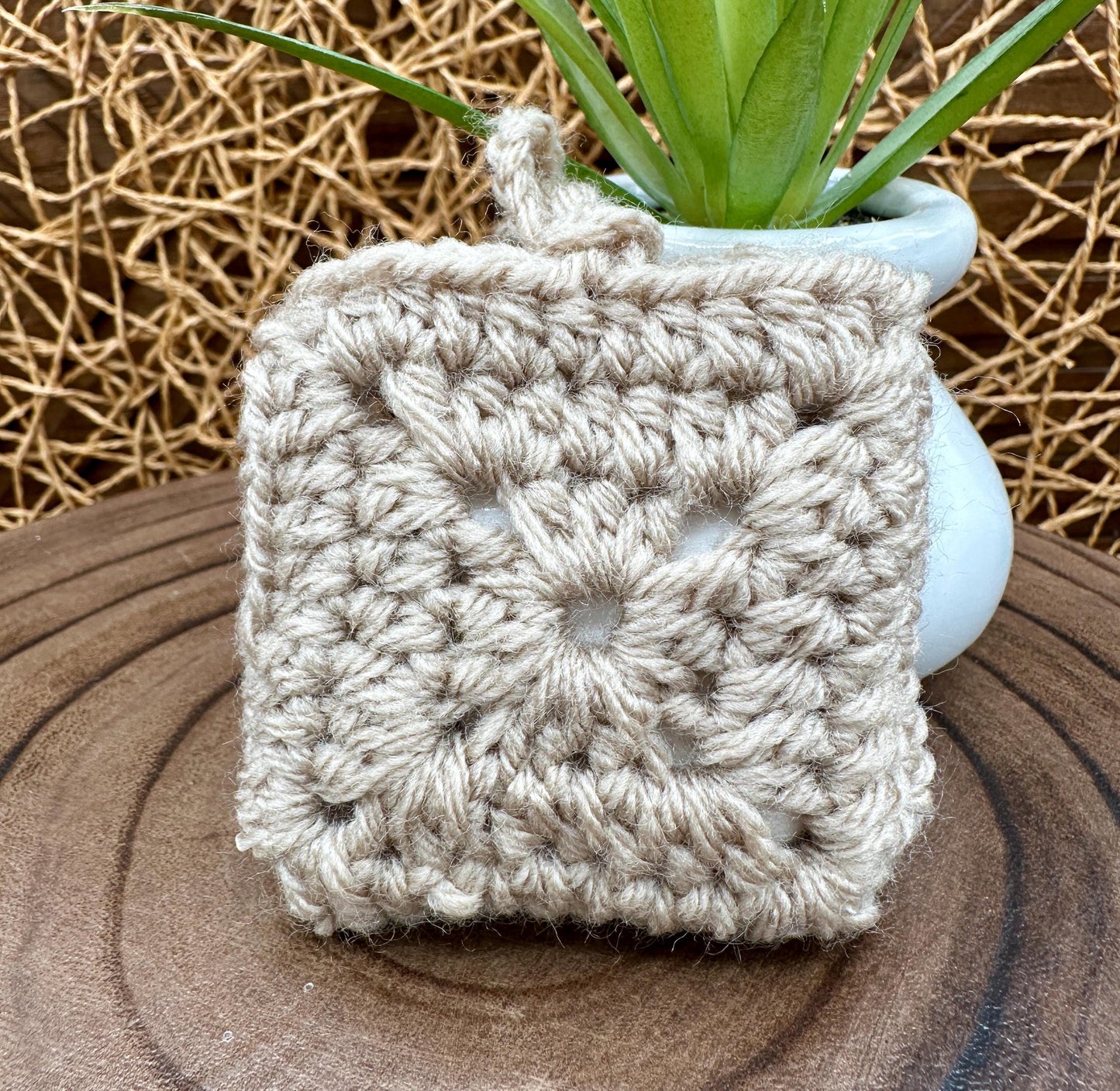 Beige Crocheted Wireless earbud case, compatible with AirPods, measures 3 T 3 H .25 D, Granny Square Design
