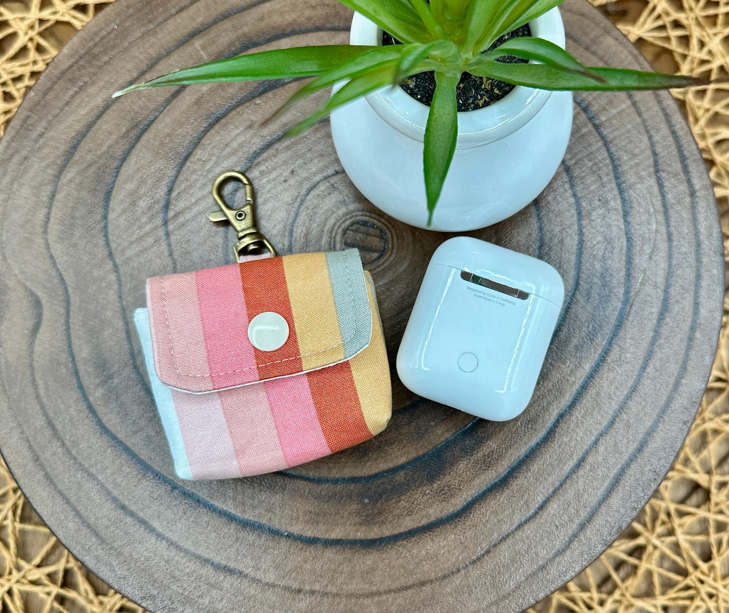 Wireless earbud case, pastel striped fabric with snap closure and swivel clasp for added protection and convenience, 3X3X.75"