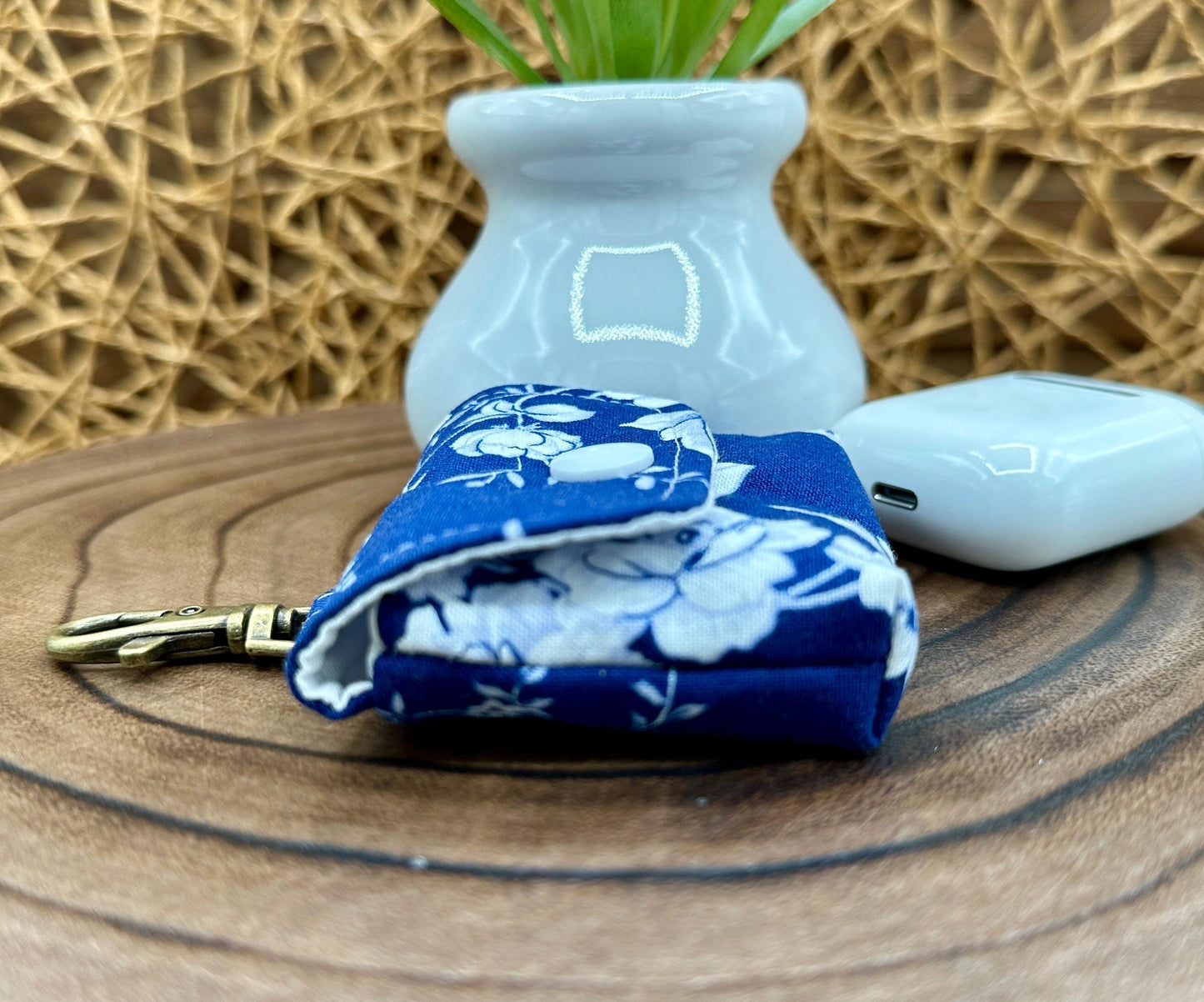 Wireless earbud case, Elegant Navy fabric with White flowers with snap closure and swivel clasp for protection and convenience, 3X3X.75"