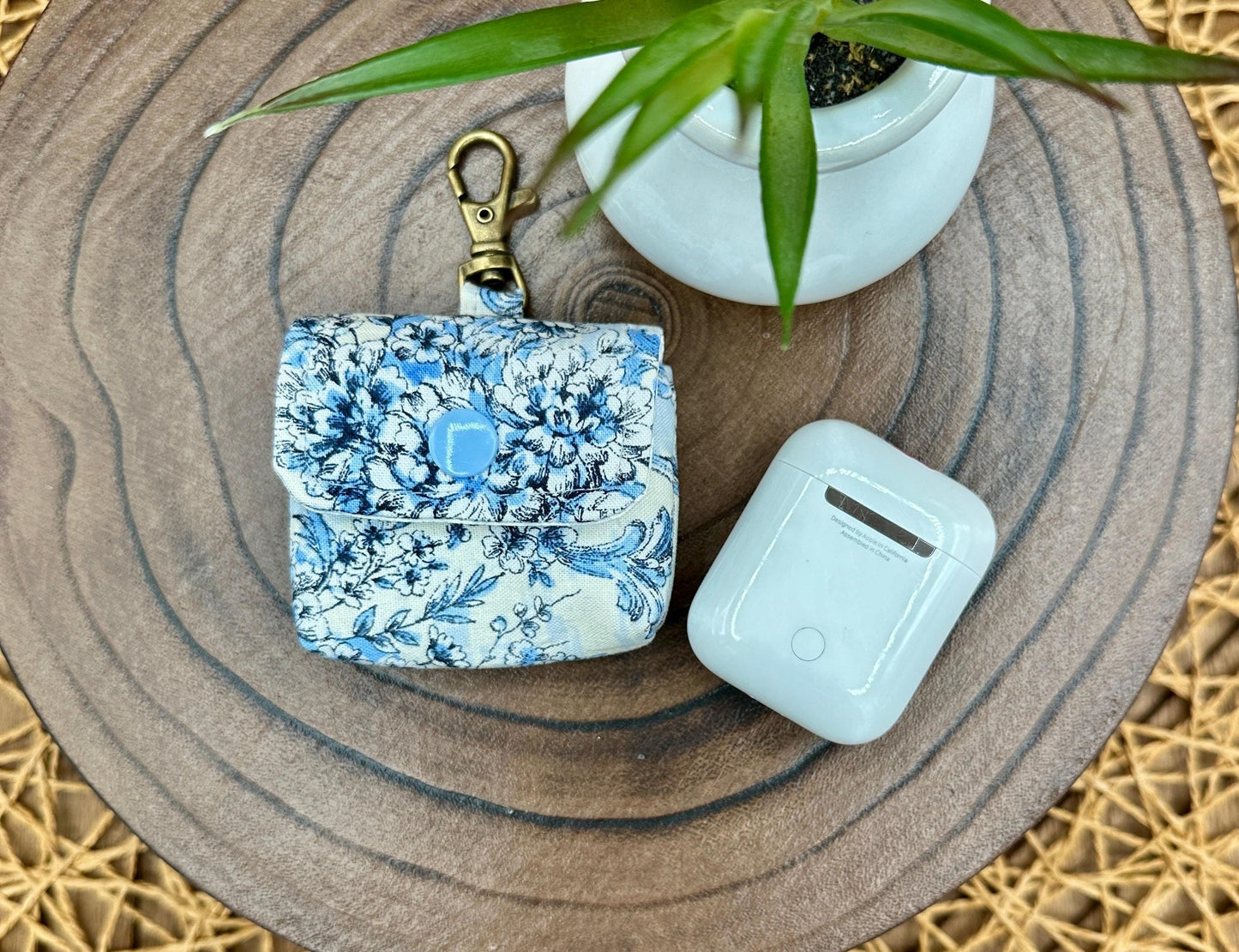 Wireless earbud case, elegant blue floral fabric with snap closure and swivel clasp for added protection and convenience, 3X3X.75"