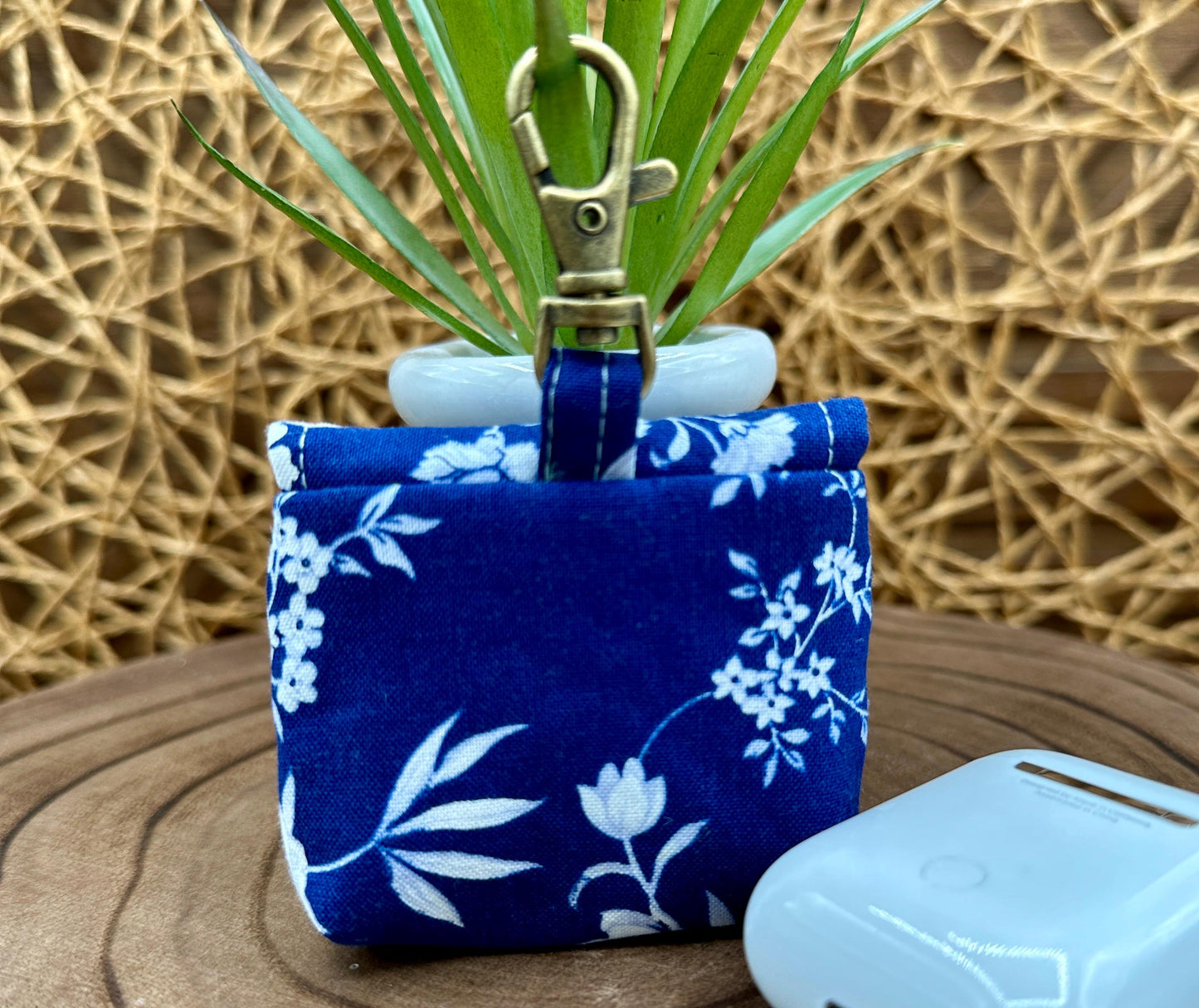 Wireless earbud case, Elegant Navy fabric with White flowers with snap closure and swivel clasp for protection and convenience, 3X3X.75"