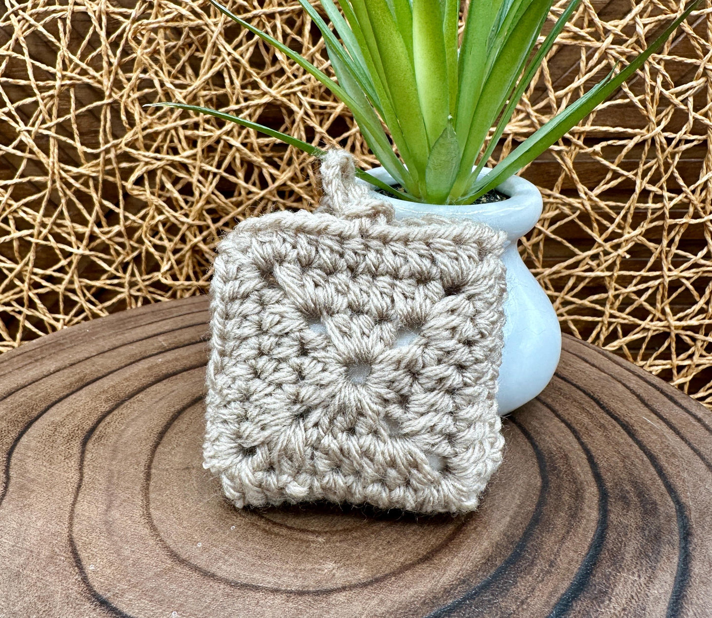 Beige Crocheted Wireless earbud case, compatible with AirPods, measures 3 T 3 H .25 D, Granny Square Design