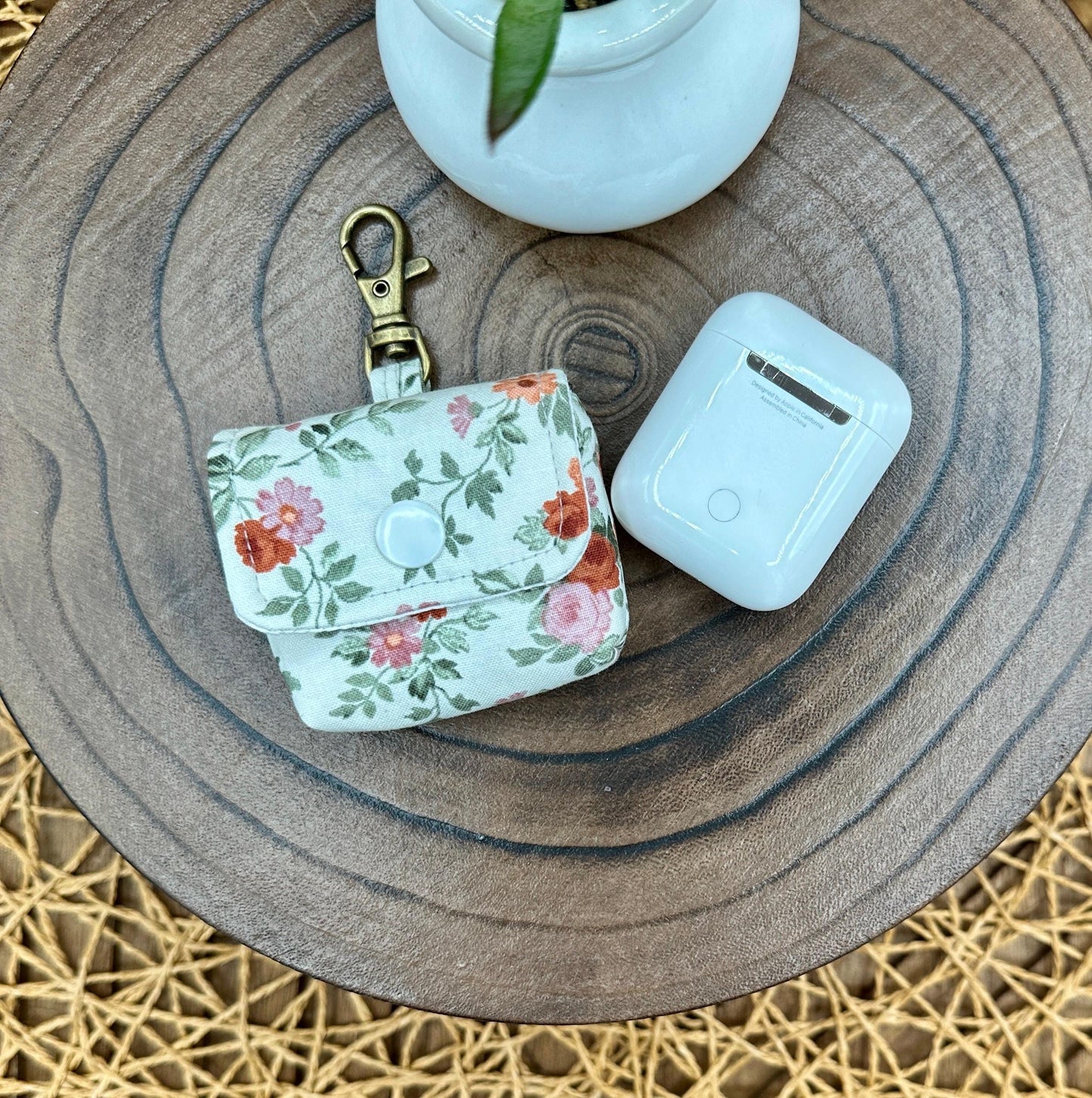 Wireless earbud case, Dainty Rust and Pink floral fabric with snap closure and swivel clasp for added protection and convenience, 3X3X.75"
