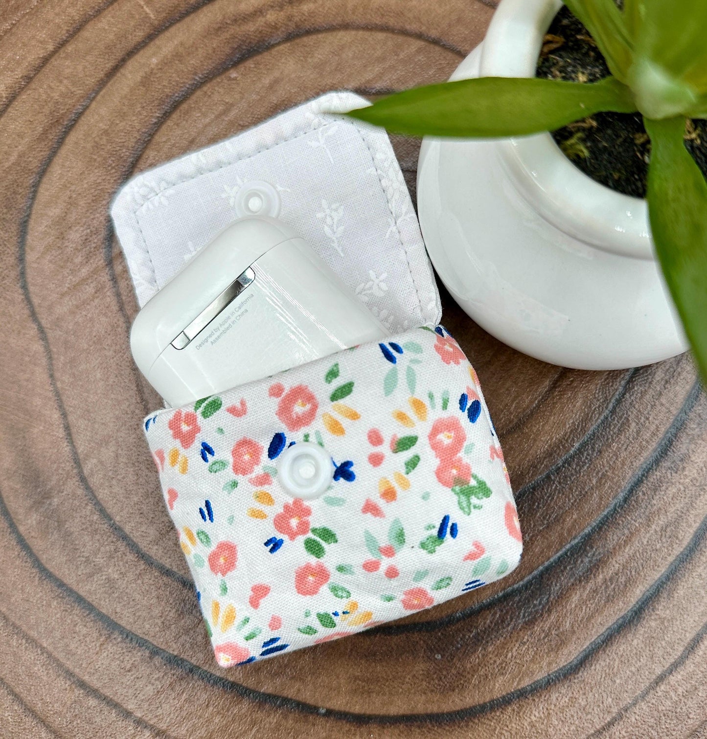 Wireless earbud case, Dainty Pink floral fabric With Blue Leaves; snap closure and swivel clasp for stylish convenience and security 3X3X.75