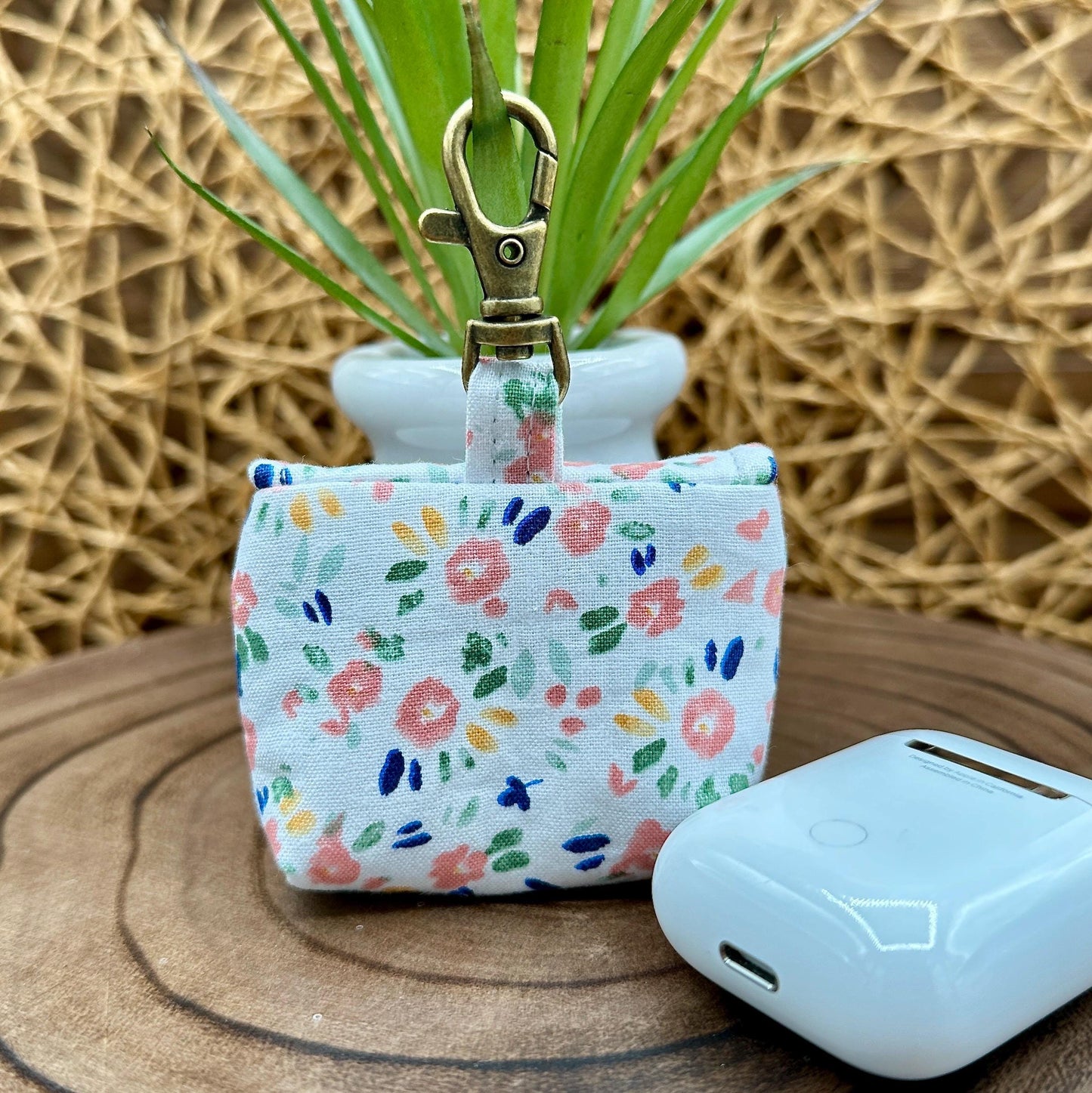 Wireless earbud case, Dainty Pink floral fabric With Blue Leaves; snap closure and swivel clasp for stylish convenience and security 3X3X.75