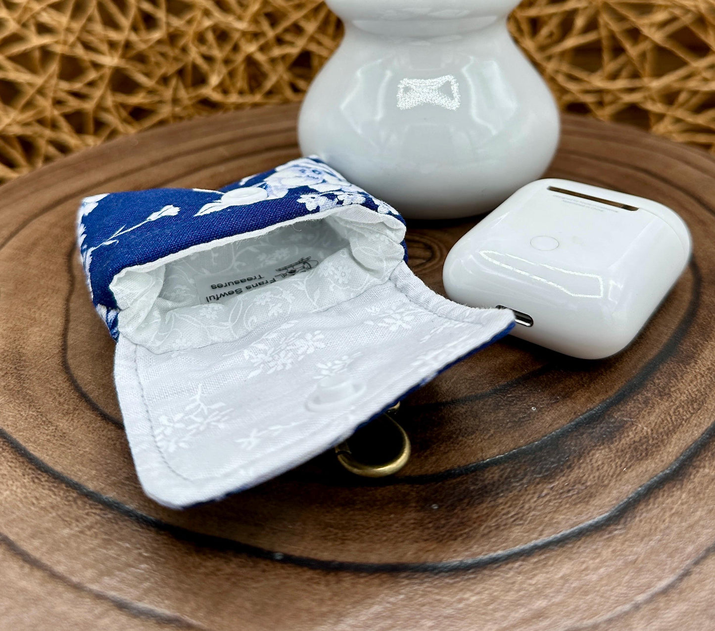 Wireless earbud case, Elegant Navy fabric with White flowers with snap closure and swivel clasp for protection and convenience, 3X3X.75"
