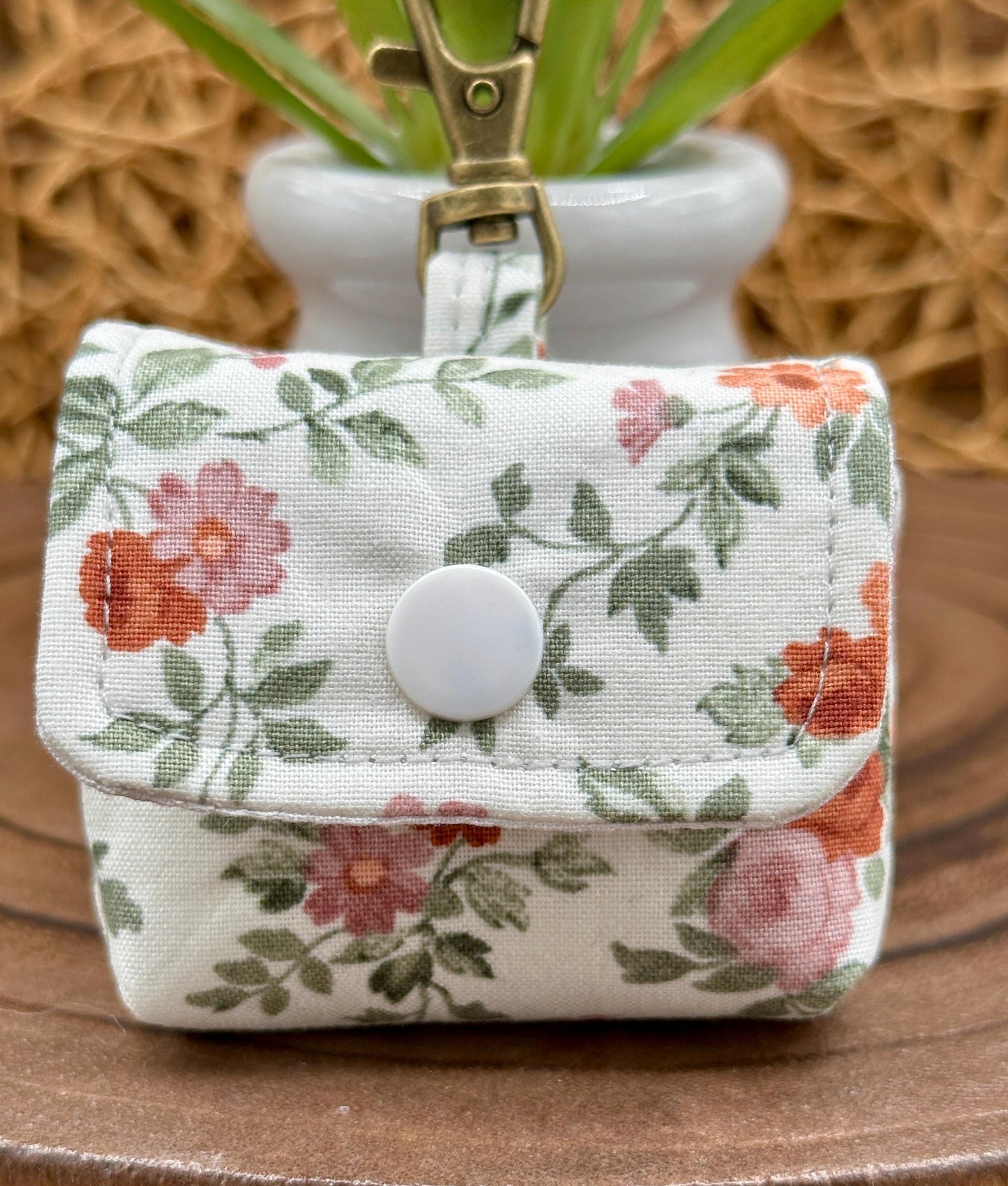 Wireless earbud case, Dainty Rust and Pink floral fabric with snap closure and swivel clasp for added protection and convenience, 3X3X.75"