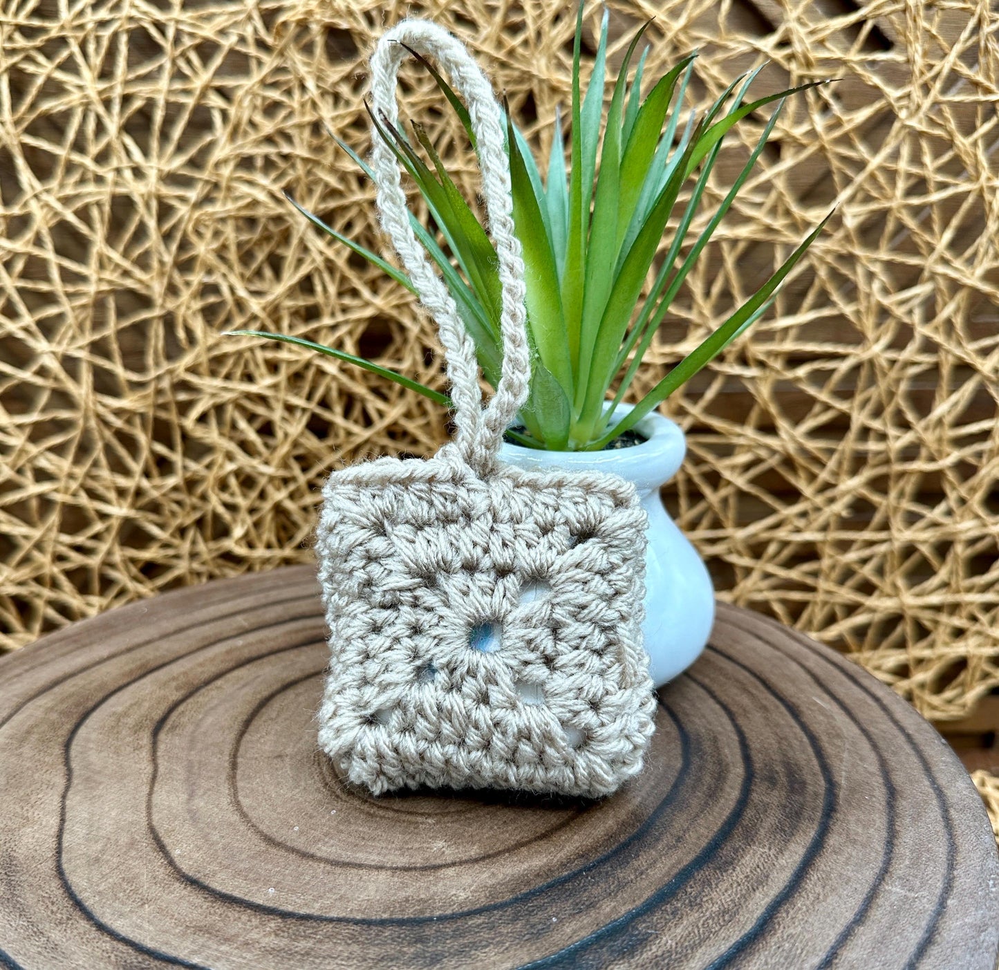 Beige Crocheted Wireless earbud case, compatible with AirPods, measures 3 T 3 H .25 D, Granny Square Design