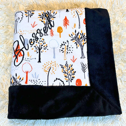 black plush minky baby blanket with a Harvest themed flannel print on the other side