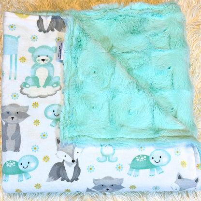 plush green swirl minky baby blanket featuring a cotton flannel flip side with adorable bears, foxes, racoons and turtles