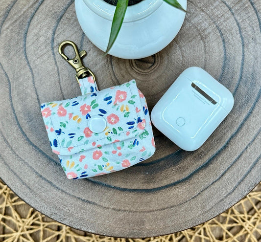 Wireless earbud case, Dainty Pink floral fabric With Blue Leaves; snap closure and swivel clasp for stylish convenience and security 3X3X.75