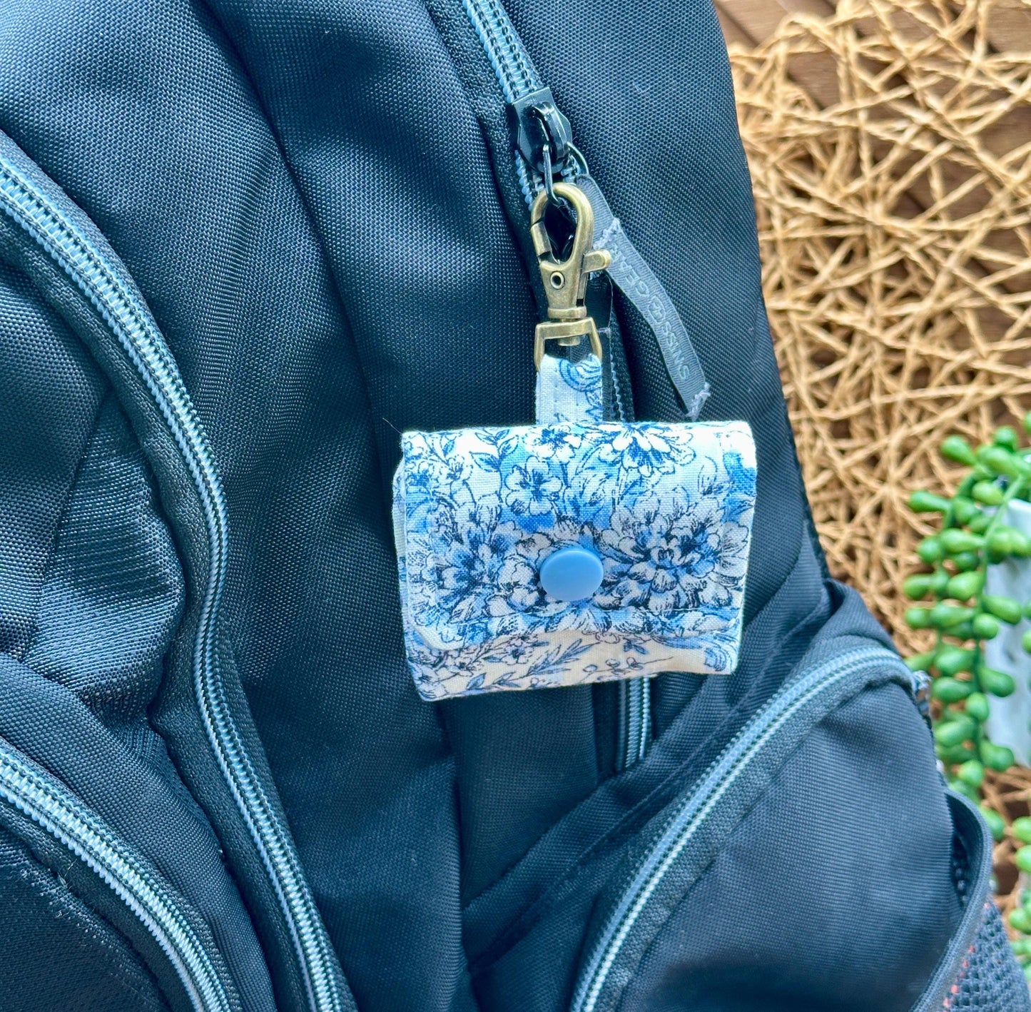 Wireless earbud case, elegant blue floral fabric with snap closure and swivel clasp for added protection and convenience, 3X3X.75"