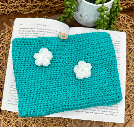 blue crocheted book sleeve with two white flowers
