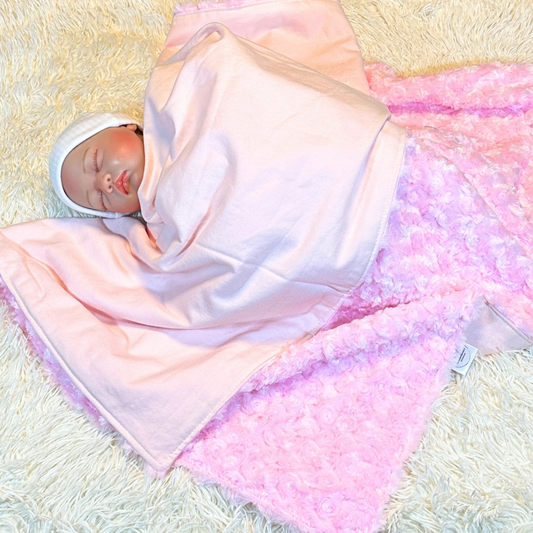 baby covered by pink rosette minky and pink flannel baby blanket - part of blanket and lovey set