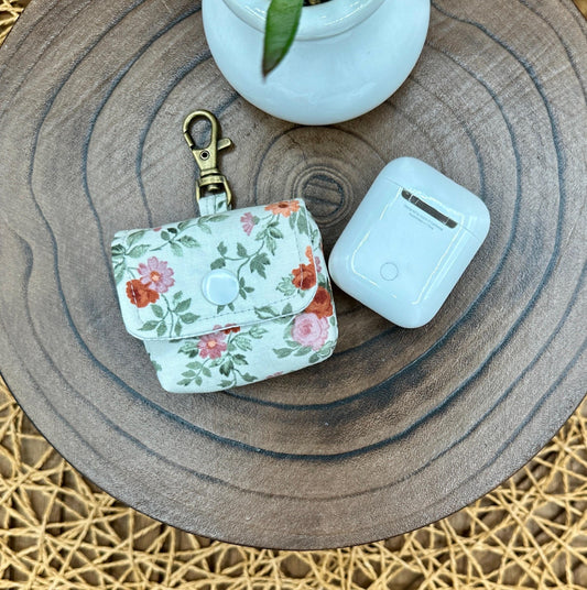 Wireless earbud case, Dainty Rust and Pink floral fabric with snap closure and swivel clasp for added protection and convenience, 3X3X.75"