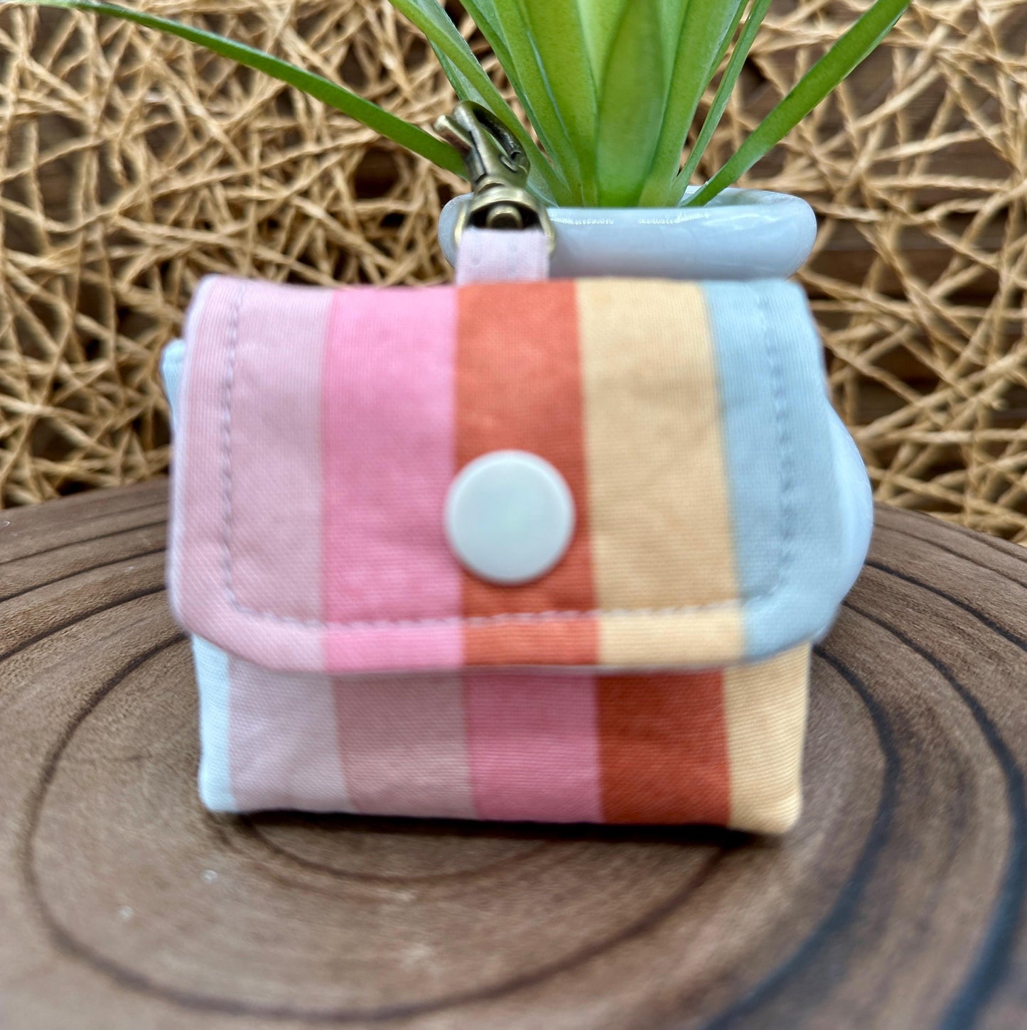 Wireless earbud case, pastel striped fabric with snap closure and swivel clasp for added protection and convenience, 3X3X.75"